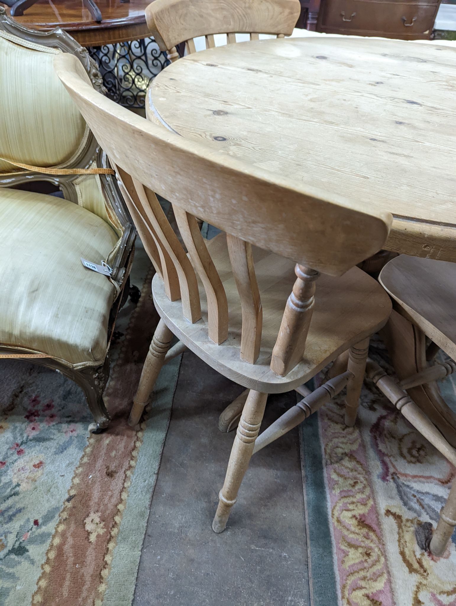 A Victorian style circular pine breakfast table, diameter 105cm, height 74cm, together with four Victorian style beech lathe back kitchen chairs